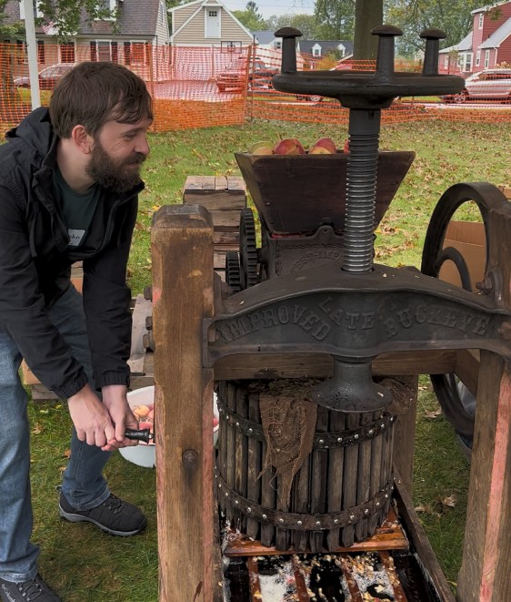 John Bauman demonstrating with antique cider press